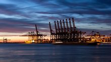 Nightview at the Maasvlakte at Rotterdam harbour with harbour cranes at sunset